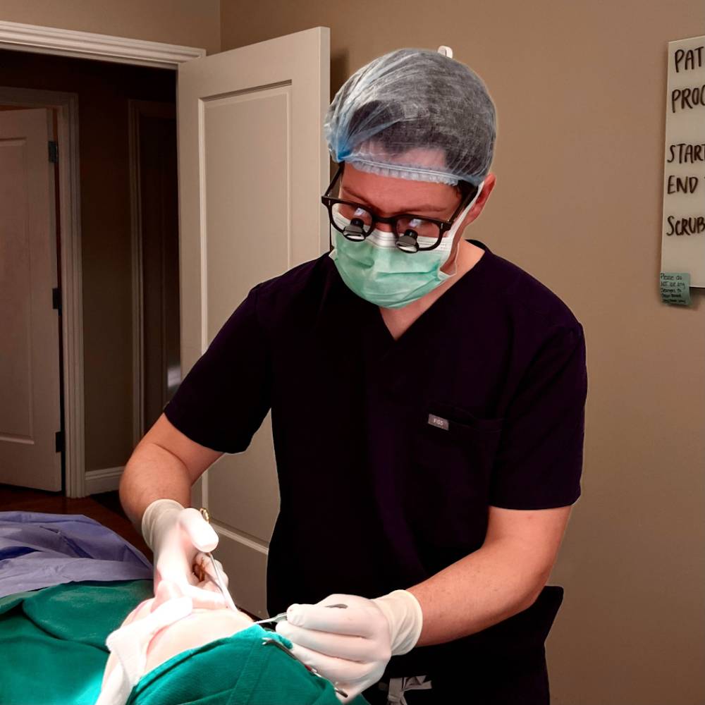 Dr. John Andre, professional headshot in a medical setting